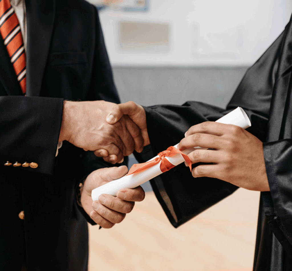 An image of a person handing a diploma to someone.