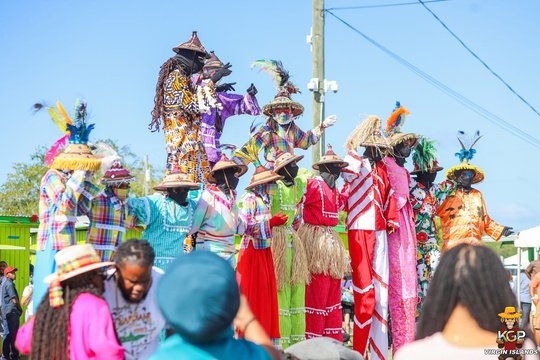Moko Jumbies in colorful costumes at the 2025 Agricultural Fair.