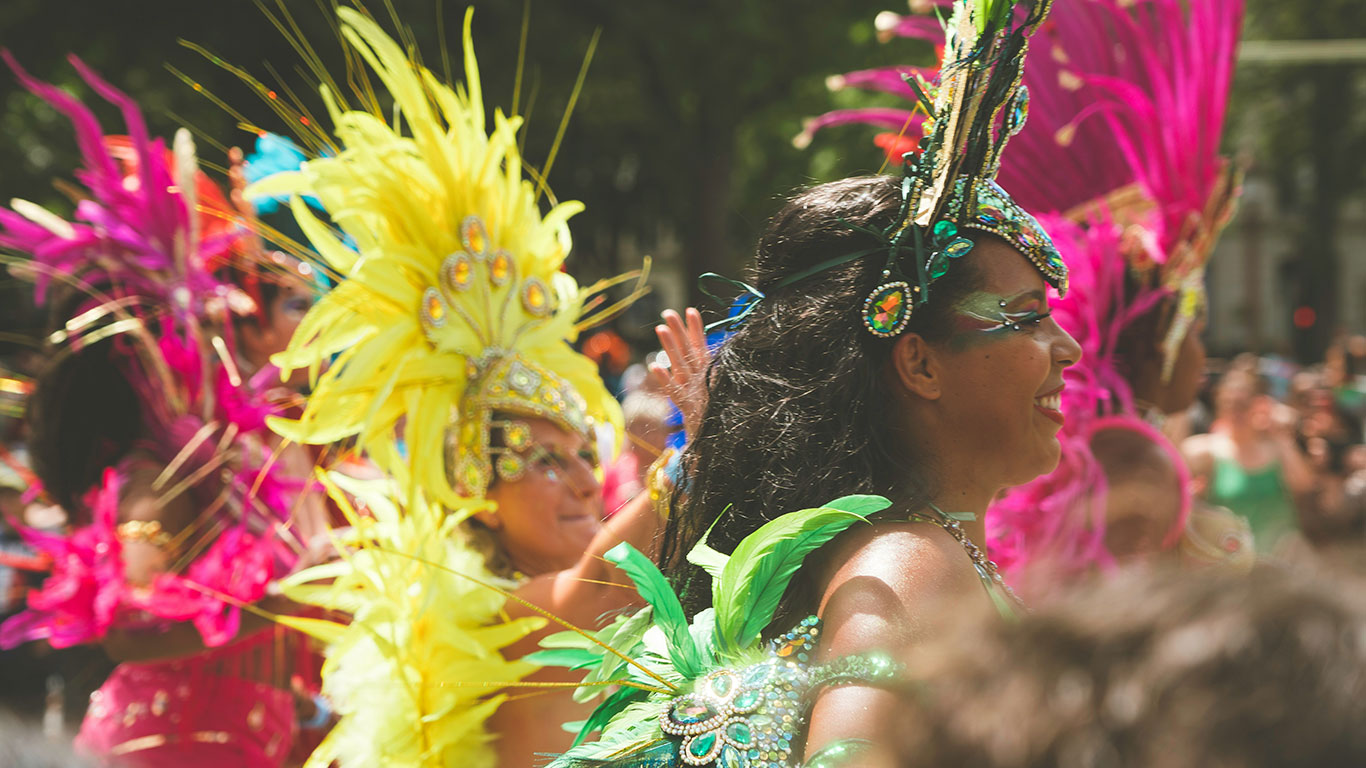 A woman in a vibrant, traditional Crucian festival costume.